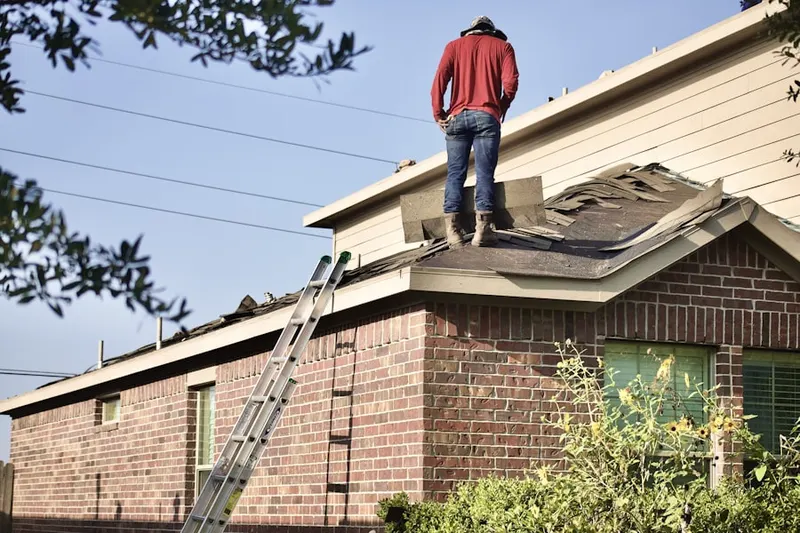 Professional roofer working on a residential roof in Gores Mill